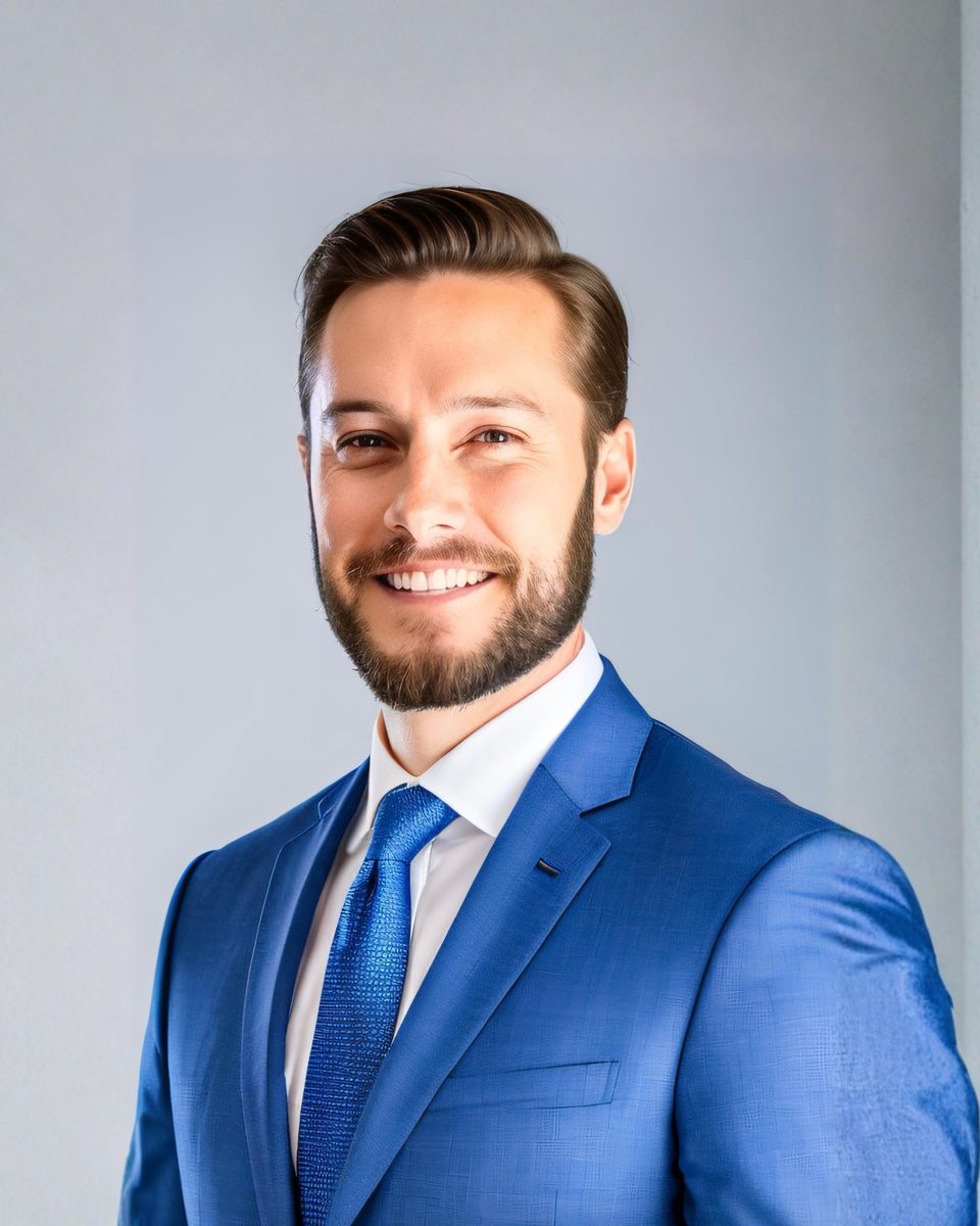 Shane M. Dixon, Managing Partner at Corbeau Tech, in a blue suit.